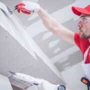 Residential Remodeling Drywall Patching. Caucasian Contractor in His 30s. Construction Theme.