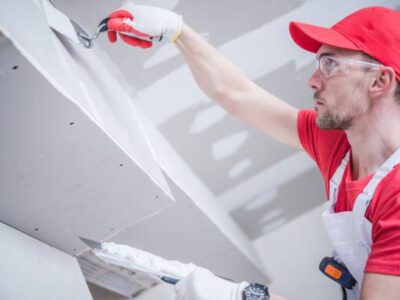 Residential Remodeling Drywall Patching. Caucasian Contractor in His 30s. Construction Theme.